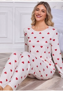 Detailed view of women's pajamas with red heart prints and ribbed texture fabric