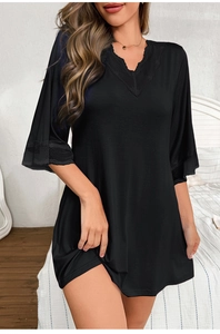 Detailed close-up of V-neckline with delicate black lace trim on modal nightdress