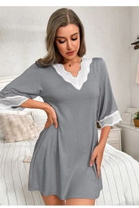 Close-up of elegant V-neckline and white lace trim on a grey modal nightgown