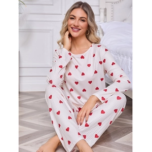 Women's white ribbed pajama set with red heart print featuring long sleeve top and pants
