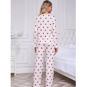 Women's pajama set featuring milk silk long sleeves and red heart print on soft cream fabric