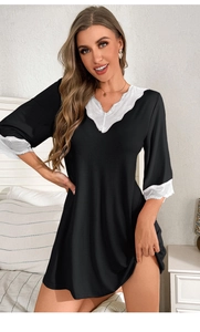 Detailed view of the V-neckline with delicate floral lace trim on a black modal nightgown