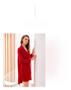 Detail of red silk satin pajama dress with black contrast piping and button-down front