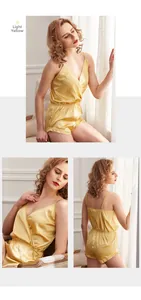 Detail view of light yellow satin camisole set with V-neck top and lace-trim shorts