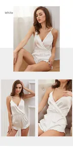 Detailed view of white silk romper pajamas with thin straps and ruffled edges