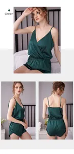 Detail of dark green satin romper with V-neck, thin straps and delicate ruffled edges