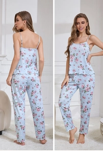 Three-piece light blue pajama set with floral patterns and delicate wavy hems