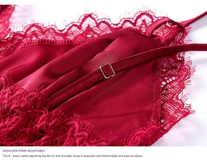 Macro detail of adjustable shoulder strap with metal buckle on red satin nightwear