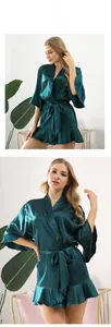 Details des dunkelgrünen Satin-Morgentitels mit elegantem Volant-Saum und Gürtel