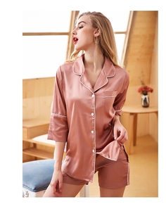Detail of pink satin pajama set featuring a lapel collar and white contrast piping accents