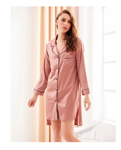 Detail view of pink satin nightgown with contrast piping, notched collar, and front buttons