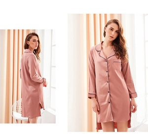 Detailed view of pink silk satin long-sleeve nightdress with navy blue piping trim