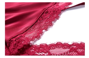Vue détaillée en gros plan du satin rouge foncé avec dentelle florale délicate sur le bord