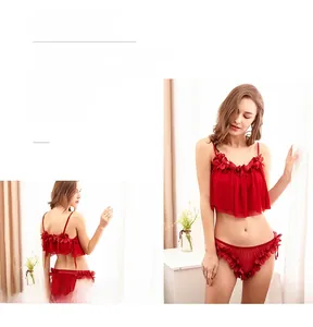 Detailed view of red lace lingerie set with 3D flower applique and mesh texture