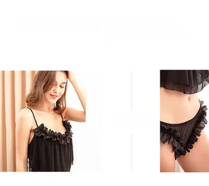 Detail of black sheer mesh lingerie set with delicate floral ruffle trim and lace textures