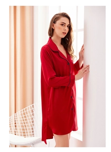 Close-up of red silk satin nightgown featuring lapel collar with dark piping detail