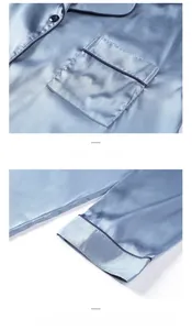 Detail of blue satin sleepwear showing front pocket and sleeve with navy piping trim