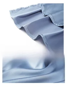 Detail showing smooth light blue silk fabric with fine stitching and satin luster texture
