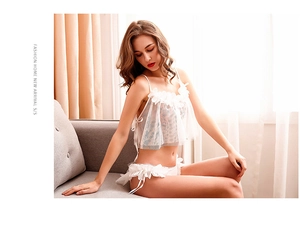 Detail of white lace lingerie set featuring 3D floral accents and sheer mesh fabric