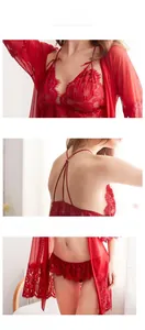 Macro detail of red lace floral embroidery and sheer mesh texture on the lingerie set