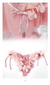 Close-up of pink sheer mesh lingerie set with 3D floral petals and side-tie details