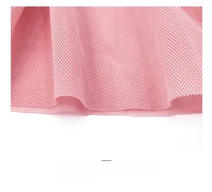 Detail shot of sheer pink mesh fabric with fine honeycomb structure and soft texture