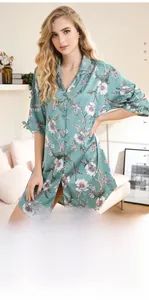 Detail of mint green floral pajama dress with bow-tie sleeves and satin finish