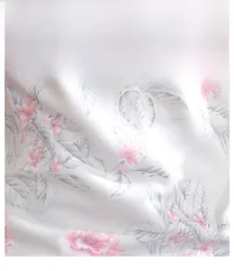 Close-up of pink floral print on smooth ice silk satin fabric with elegant drape