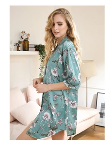 Silk-like floral satin loungewear with pastel blossoms in a cozy home setting