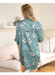 Detail of the elegant floral bird print robe with bow tie cuffs in silky teal fabric