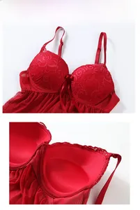 Close-up of red lace cups with intricate floral patterns and a satin bow detail