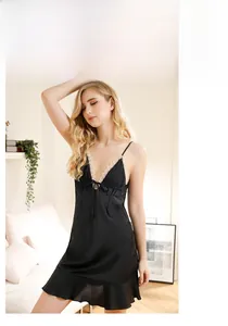Exquisite lace trim on black satin slip dress with elegant ruffle hem detail