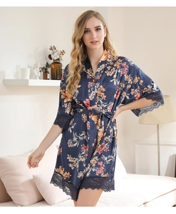 Close-up of deep blue floral satin robe with intricate eyelash lace trim and waist tie