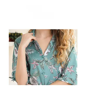 Detail view of floral print satin pajamas with a V-neckline and decorative button closure