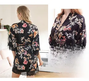 Detail of floral satin robe featuring intricate black lace trim on sleeves and V-neckline
