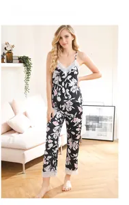 Close-up of black floral camisole set with white lace trim and silky texture