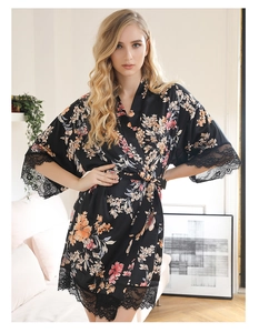 Detail of floral satin robe featuring intricate black lace trim on sleeves and hemline