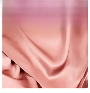 Detailed view of pink faux silk satin fabric texture showing smooth glossy finish and drape