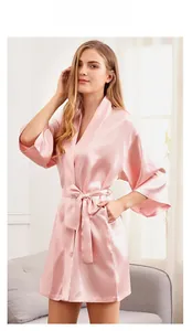 Detailed view of pale pink satin bridal robe with silk sheen and convenient side pockets