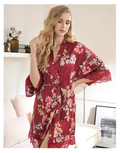 Detail of burgundy satin robe featuring delicate floral prints and eyelash lace sleeves