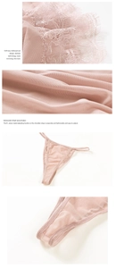 Detailed macro shot of delicate pink lace embroidery and sheer mesh fabric textures