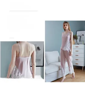 Silk-like pajama set featuring V-neck camisole and pants with delicate lace trim
