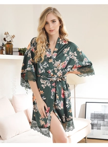 Detail of dark green floral satin robe with lace trim on sleeves and hem