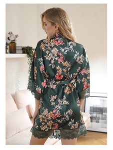 Detailed view of dark green satin floral robe with elegant lace trim on the sleeves