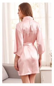 Pink satin bridesmaid robe with white embroidery detail on the back and matching waist belt