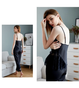 Close-up of black satin camisole set featuring delicate floral lace trim and sleek fabric