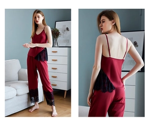 Close-up of burgundy satin camisole set with black lace trim and matching trousers