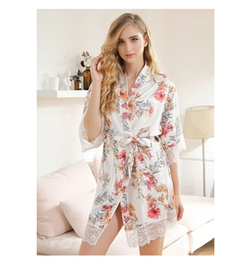 Detailed lace trim on floral satin bridal robe hem and sleeve in white floral pattern