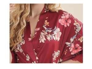 Detailed view of burgundy satin robe with floral print and lace trim on sleeves