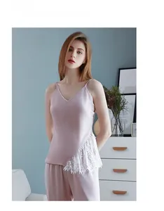 Detail of dusty pink satin camisole set featuring delicate white lace patchwork sides